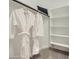 Spacious walk-in closet with built-in shelving and two hanging white bathrobes at 8149 E Petunia Ave # 1035, Mesa, AZ 85212