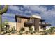 Modern home showcasing stone accents and balconies with desert views at 8167 E Leaning Rock Rd # 193, Scottsdale, AZ 85266