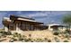 Modern home with a patio, lush desert plants and large windows at 8167 E Leaning Rock Rd # 193, Scottsdale, AZ 85266