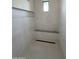 Clean and modern shower with gray tile, a built-in shelf, and a sleek design at 8167 E Leaning Rock Rd # 193, Scottsdale, AZ 85266