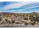 Wide aerial shot showcasing a desert community with sprawling properties and distant mountain ranges at 8395 E Leaning Rock Rd # 187, Scottsdale, AZ 85266