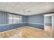 Spacious bedroom with wood-look flooring, a ceiling fan, and large windows offering lots of natural light at 8600 E Broadway Rd # 28, Mesa, AZ 85208