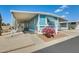 Inviting blue home featuring a carport, desert landscaping, and eye-catching magenta cactus in the front yard at 8600 E Broadway Rd # 28, Mesa, AZ 85208