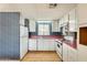 Bright kitchen with white cabinetry, appliances, a pink countertop, and a window bringing natural light into the space at 8600 E Broadway Rd # 28, Mesa, AZ 85208