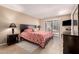 This is a main bedroom featuring a King bed, two nightstands, and a door leading to the patio at 9028 E Winchcomb Dr, Scottsdale, AZ 85260