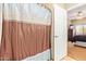 Bathroom featuring a shower and bath and an open doorway to the bedroom at 10030 W Indian School Rd # 226, Phoenix, AZ 85037