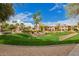 Beautifully landscaped grounds with a grassy area and mature trees, perfect for outdoor activities at 10030 W Indian School Rd # 226, Phoenix, AZ 85037