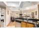 Cozy kitchen and living area featuring granite countertops and modern appliances at 10030 W Indian School Rd # 226, Phoenix, AZ 85037