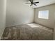 Well-lit bedroom with a ceiling fan, carpeted floor, and natural light from a window at 10401 N 52Nd St # 124, Paradise Valley, AZ 85253