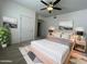 Bright bedroom with a ceiling fan, carpeted floor, and beach themed artwork on the walls at 10401 N 52Nd St # 124, Paradise Valley, AZ 85253