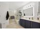 Stylish bathroom featuring a glass-enclosed shower, modern vanity, and contemporary lighting at 10505 W Wilshire Dr, Avondale, AZ 85392