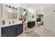 Elegant bathroom featuring dual vanities, decorative accent wall, and modern fixtures at 10505 W Wilshire Dr, Avondale, AZ 85392