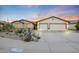 Charming home with a well-maintained desert landscape and a three-car garage at 10505 W Wilshire Dr, Avondale, AZ 85392