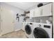 Functional laundry room with modern appliances, ample storage, and a clean design at 10505 W Wilshire Dr, Avondale, AZ 85392