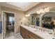 Bathroom features a double sink vanity, tile flooring and a luxurious bathtub at 10557 E Fanfol Ln, Scottsdale, AZ 85258