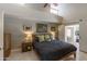 Cozy bedroom with high ceilings, neutral colors, and a barn door leading to a walk-in closet at 10557 E Fanfol Ln, Scottsdale, AZ 85258