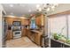 Well-lit kitchen with wooden cabinets, stainless steel appliances, and a view to the backyard at 10557 E Fanfol Ln, Scottsdale, AZ 85258