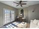 Cozy living room featuring French doors, light wood floors, and a modern ceiling fan at 10557 E Fanfol Ln, Scottsdale, AZ 85258