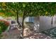 Private brick patio featuring outdoor seating and a mature citrus tree at 10557 E Fanfol Ln, Scottsdale, AZ 85258