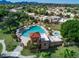 Aerial view of a large community pool area surrounded by lush greenery and residential buildings at 10557 E Fanfol Ln, Scottsdale, AZ 85258