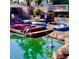 Waterfront area featuring boats and kayaks, with tropical landscaping and reflections on the water at 10557 E Fanfol Ln, Scottsdale, AZ 85258