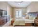 Cozy bedroom with a dark wood dresser and bedframe, a window, and soft natural lighting at 10672 N 140Th Way, Scottsdale, AZ 85259