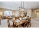 Dining room with a wooden table, a modern light fixture, and large windows at 10672 N 140Th Way, Scottsdale, AZ 85259