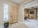 Entryway foyer with a patterned wood door, tiled flooring, and a view into the study at 10672 N 140Th Way, Scottsdale, AZ 85259