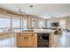 Open kitchen with island, dishwasher, and view to the living room and scenic outdoor landscape at 10672 N 140Th Way, Scottsdale, AZ 85259