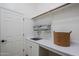 A well-lit laundry room with a sink and storage at 10672 N 140Th Way, Scottsdale, AZ 85259