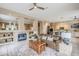 Open-concept living space with a fireplace, comfortable seating, and a glimpse of the kitchen at 10672 N 140Th Way, Scottsdale, AZ 85259