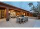 Spacious covered patio with outdoor seating, a dining table, and views of the landscaped yard at 10672 N 140Th Way, Scottsdale, AZ 85259