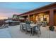 Covered patio area with an outdoor dining table, lounge seating, and a hot tub at 10672 N 140Th Way, Scottsdale, AZ 85259