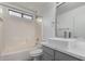 Bathroom with a sleek vessel sink, a shower-tub combo, and a framed mirror at 1100 E Vernoa St, San Tan Valley, AZ 85140