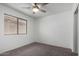 Neutral bedroom with a ceiling fan, window, and carpet at 1100 E Vernoa St, San Tan Valley, AZ 85140