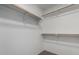 Spacious walk-in closet featuring white walls and wooden rods for ample storage at 1100 E Vernoa St, San Tan Valley, AZ 85140