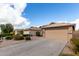 Neighborhood street view featuring similar single-story homes with well-manicured lawns and attached two-car garages at 1100 E Vernoa St, San Tan Valley, AZ 85140