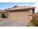 This charming home has a two-car garage, desert landscaping, and a tile roof at 1100 E Vernoa St, San Tan Valley, AZ 85140