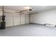 Two-car garage with a grey epoxy floor, garage door opener, and plenty of room for storage at 1100 E Vernoa St, San Tan Valley, AZ 85140