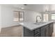 Spacious kitchen island featuring a modern sink, gray cabinetry, and quartz countertops at 1100 E Vernoa St, San Tan Valley, AZ 85140