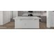 A view of a kitchen island featuring marbled white countertops and gray cabinetry at 1100 E Vernoa St, San Tan Valley, AZ 85140