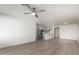 Expansive living area showcasing sleek floors that leads into an eat-in kitchen with light gray cabinetry and stainless appliances at 1100 E Vernoa St, San Tan Valley, AZ 85140