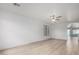 Spacious living room boasting wood-look floors, neutral paint, a ceiling fan, and a window for natural light at 1100 E Vernoa St, San Tan Valley, AZ 85140