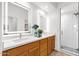 Modern bathroom featuring double sinks with lighted mirrors and a glass-enclosed shower at 11686 N Spotted Horse Way, Fountain Hills, AZ 85268