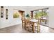 Bright dining room with tile floors and a wooden table set with a view of the backyard at 11686 N Spotted Horse Way, Fountain Hills, AZ 85268