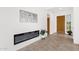 Hallway with modern electric fireplace, decorative wall art, tile floors and wooden doors at 11686 N Spotted Horse Way, Fountain Hills, AZ 85268