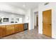 Kitchen features a beverage refrigerator, white countertops and light wood cabinetry at 11686 N Spotted Horse Way, Fountain Hills, AZ 85268