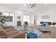 Open-concept living room featuring modern furniture, fireplace, and access to a covered patio at 11686 N Spotted Horse Way, Fountain Hills, AZ 85268