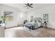 Bright main bedroom with tiled floor, ceiling fan, accent chair, bench, and window with mountain views at 11686 N Spotted Horse Way, Fountain Hills, AZ 85268