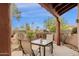 Inviting covered patio with outdoor seating and a view of the surrounding desert landscape at 11686 N Spotted Horse Way, Fountain Hills, AZ 85268